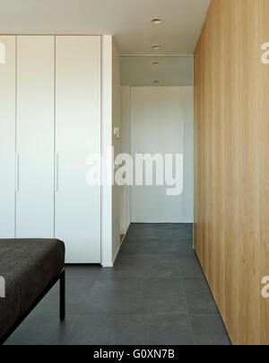 Escorial Apartment, Barcelona, Spain. Partial view of modern bedroom and grey bedding. Stock Photo