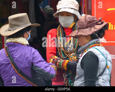 Tibetan women selling beads, necklaces and bracelets along the main street in Lhasa, Tibet. Stock Photo