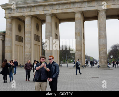 People taking selfies in front of the Brandenburg Gate in Berlin Stock Photo