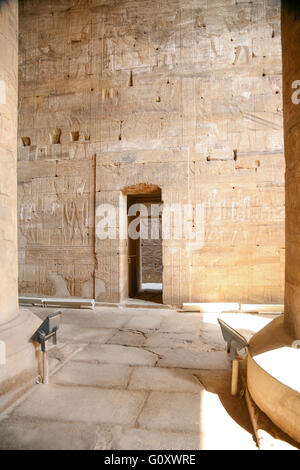 small door, stone wall of Egyptian Edfu Temple of falcon god Horus, with carving figures and hieroglyphs, in Egypt, Africa Stock Photo