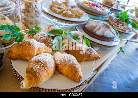 Homemade sweet pastries with fruit, jam and croissants for breakfast Stock Photo