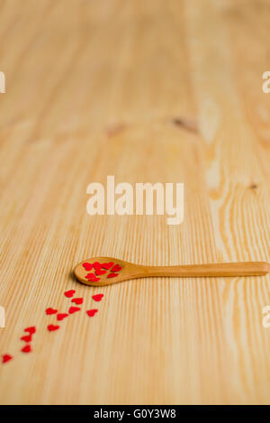 Wooden spoon with red love hearts Stock Photo