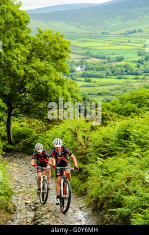 Mountain bikers on the climb of Slieau Whallian in the Isle of Man Stock Photo