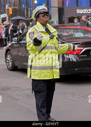 Female New York City Traffic Enforcement Officer directing cars on Broadway in Midtown Manhattan in New York City. Stock Photo