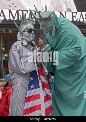 Two costumed characters who solicit money for photographs in Times Square in midtown Manhattan, New York City Stock Photo