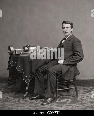 Thomas Alva Edison, 1847 –1931. American inventor and businessman, here seen seated by his 1877 invention, the phonograph.  Photograph by Matthew Brady. Stock Photo