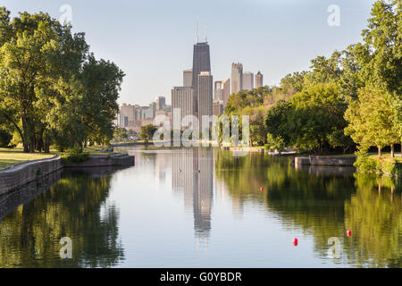 Skyline of Chicago reflected in the South Lagoon at Lincoln Park in Chicago, Illinois, USA