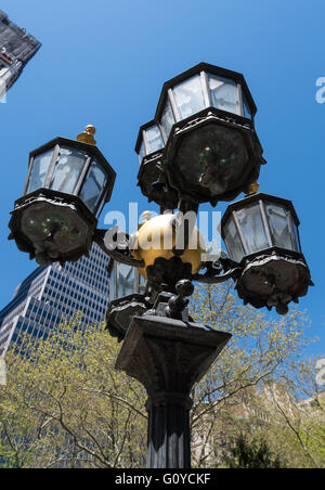 Low angle view of ornate black and gold lamppost in City Hall Park, New York City Stock Photo