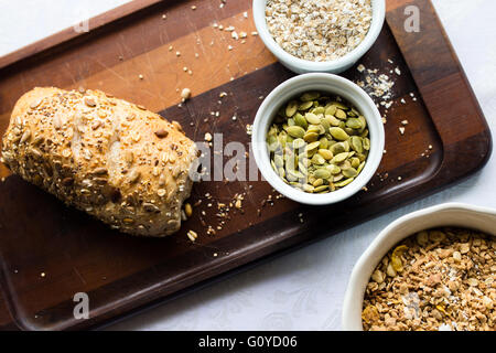 Pumpkin seeds, oats, and mix of grains with bread Stock Photo