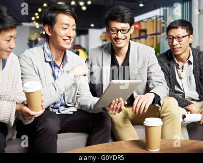 young asian businesspeople using tablet computer Stock Photo