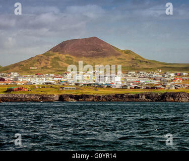 August 3, 2015 - Infamous Eldfell volcano, over 200 m (660 ft) high, overlooking Heimaey port on Heimaey Island, in the Westman Islands archipelago group (Vestmannaeyjar), scattered off the south coast of Iceland. In 1973, without warning, lava flow and volcanic ash, from its violent eruption destroyed half the town and threatened to close the harbor, its main income source. Dependent on its fishing industry, but noted for its seabird population, tourism and bird watching are a growing sector of the economy of Heimaey as Iceland becomes a favorite tourist destination. (Credit Image: © Arnold D Stock Photo