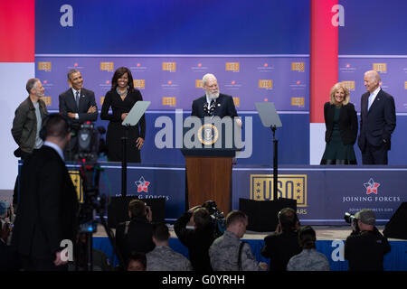 Washington DC, USA. 5th May, 2016. Former Late Show Host David Letterman does a stand up routine during a comedy show in celebration of the 75th anniversary of the USO and the 5th anniversary of Joining Forces at Joint Base Andrews May 5, 2016 in Washington, D.C. Joining Letterman on stage are (L-R): Comedian Jon Stewart, President Barack Obama, First Lady Michelle Obama, Dr. Jill Biden and Vice President Joe Biden. Credit:  Planetpix/Alamy Live News Stock Photo