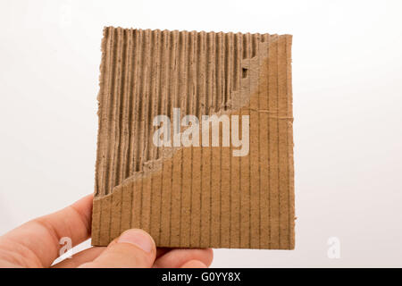 Piece of torn paper in hand on a white background Stock Photo