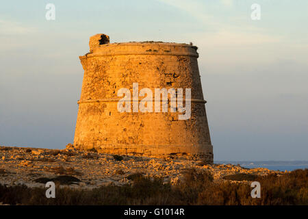 Garroveret Tower on suntet. Torre des Garroveret - one of the towers on Formentera, Balearic Islands, Spain. Stock Photo