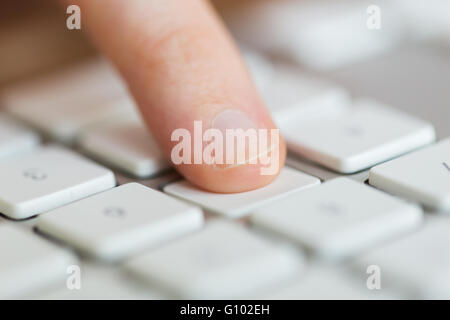 close up of finger pressing button on keyboard Stock Photo