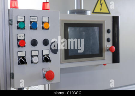 Control panel of assembly line with colored buttons. All potential trademarks are removed. Stock Photo