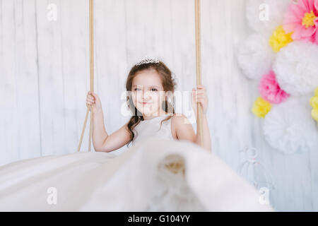 Girl riding on a swing Stock Photo