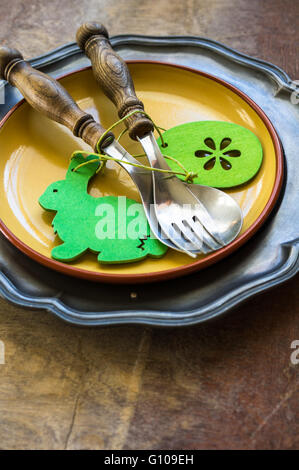 Table setting with vintage plate and silverware for Easter celebration Stock Photo