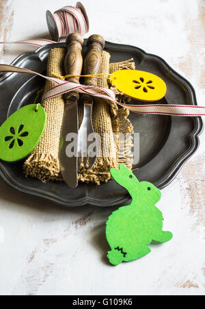 Table setting with vintage plate and silverware for Easter celebration Stock Photo