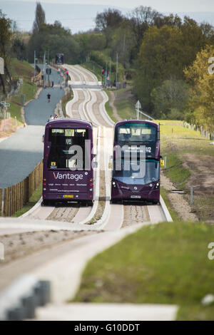 Two double decker buses passing on new concrete guided busway Stock Photo