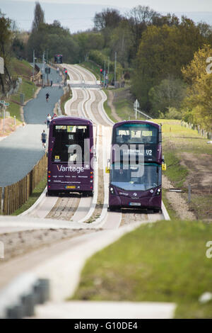 Two double decker buses passing on new concrete guided busway Stock Photo