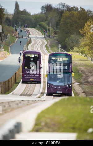 Two double decker buses passing on new concrete guided busway Stock Photo