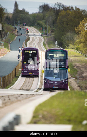 Two double decker buses passing on new concrete guided busway Stock Photo
