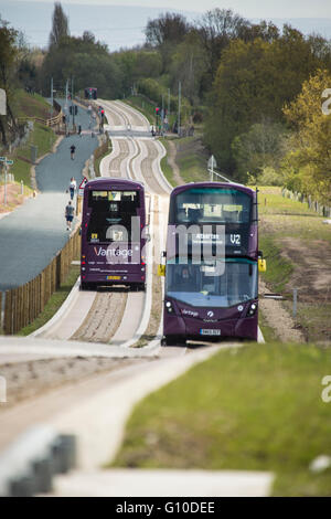 Two double decker buses passing on new concrete guided busway Stock Photo