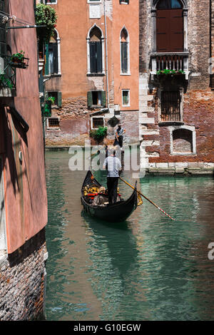 Riding Gondola Along one of the Many Venetian Canals, Italy Stock Photo