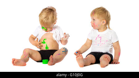 Twins brothers playing with paint, isolated on white. Stock Photo