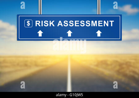 risk assessment words on blue road sign with blurred background Stock Photo