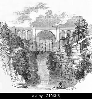 19th Century view of the Ballochmyle Viaduct is the highest extant railway viaduct in Britain. It is 169 feet (52 m) high, and carries the railway over the River Ayr close to the towns of Mauchline and Catrine, East Ayrshire, Scotland, Stock Photo