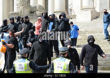 Portsmouth, UK. 7th May 2016. Masked protesters stand as they gesture to anti-fascist groups. Credit: Marc Ward/Alamy Live News Stock Photo