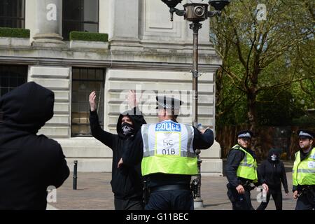 Portsmouth, UK. 7th May 2016. Another gestures for a fight as police funnel them from the protest. Credit: Marc Ward/Alamy Live News Stock Photo