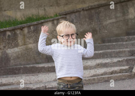 Happy child with falling down glasses, outdoors Stock Photo