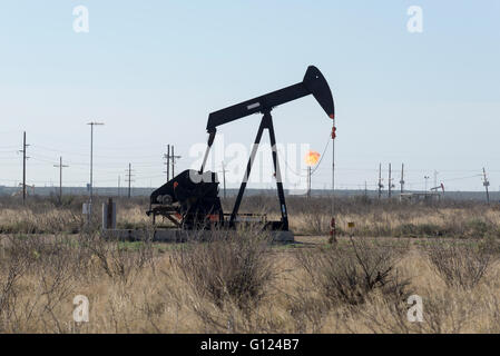 Powerlines, gas flarring and pump jacks in West Texas. Stock Photo