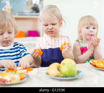 A sour apple. Cute girl child with ripe autumn crops. Little girl ...