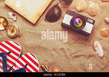 Summer holiday vacation accessories on beach sand, summertime lifestyle objects in flat lay top view arrangement. Stock Photo