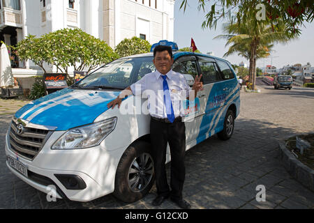 A local taxi driver poses by his car at the Champa Love Lock Bridge resort in Nha Trang Vietnam Stock Photo