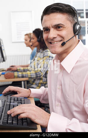 Male Customer Services Agent In Call Centre Stock Photo