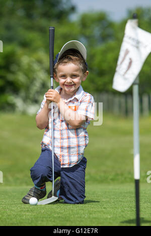 young boy and father playing golf Stock Photo