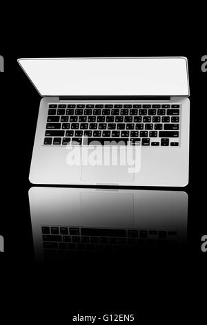 computer and internet concept: modern laptop or silver business notebook isolated on black background. Stock Photo