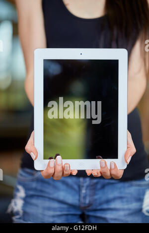 Young caucasian woman holding tablet Stock Photo