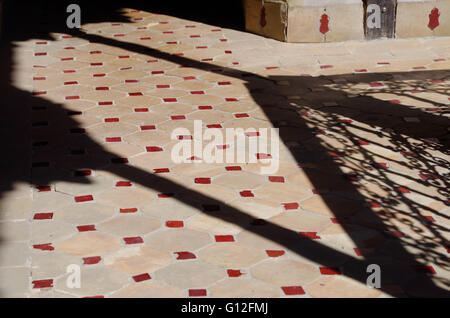 Deep shadows on a tiled floor Stock Photo