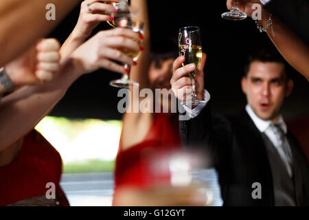 at the wedding of a young and guests raise their glasses Stock Photo