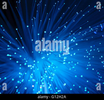 optical fibres dinamic flying from deep on technology background Stock Photo