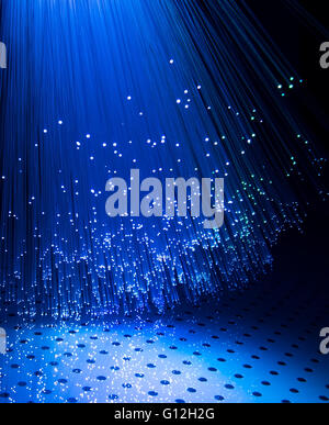 optical fibres dinamic flying from deep on technology background Stock Photo