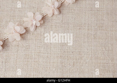 Artificial flowers and lace on linen, copy space background, selective focus, vintage tone Stock Photo
