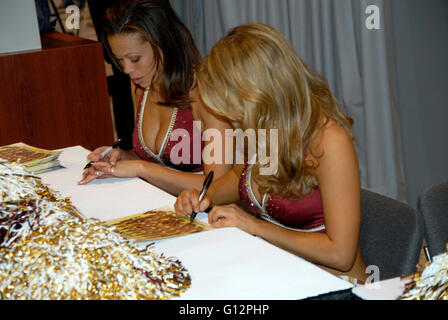 Two members of the Washington Redskins cheerleaders sign autographs Stock Photo