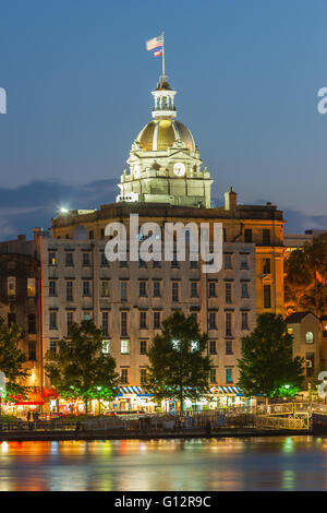 The lights of River Street, City Hall, and the skyline are reflected in the Savannah River at twilight in Savannah, Georgia. Stock Photo